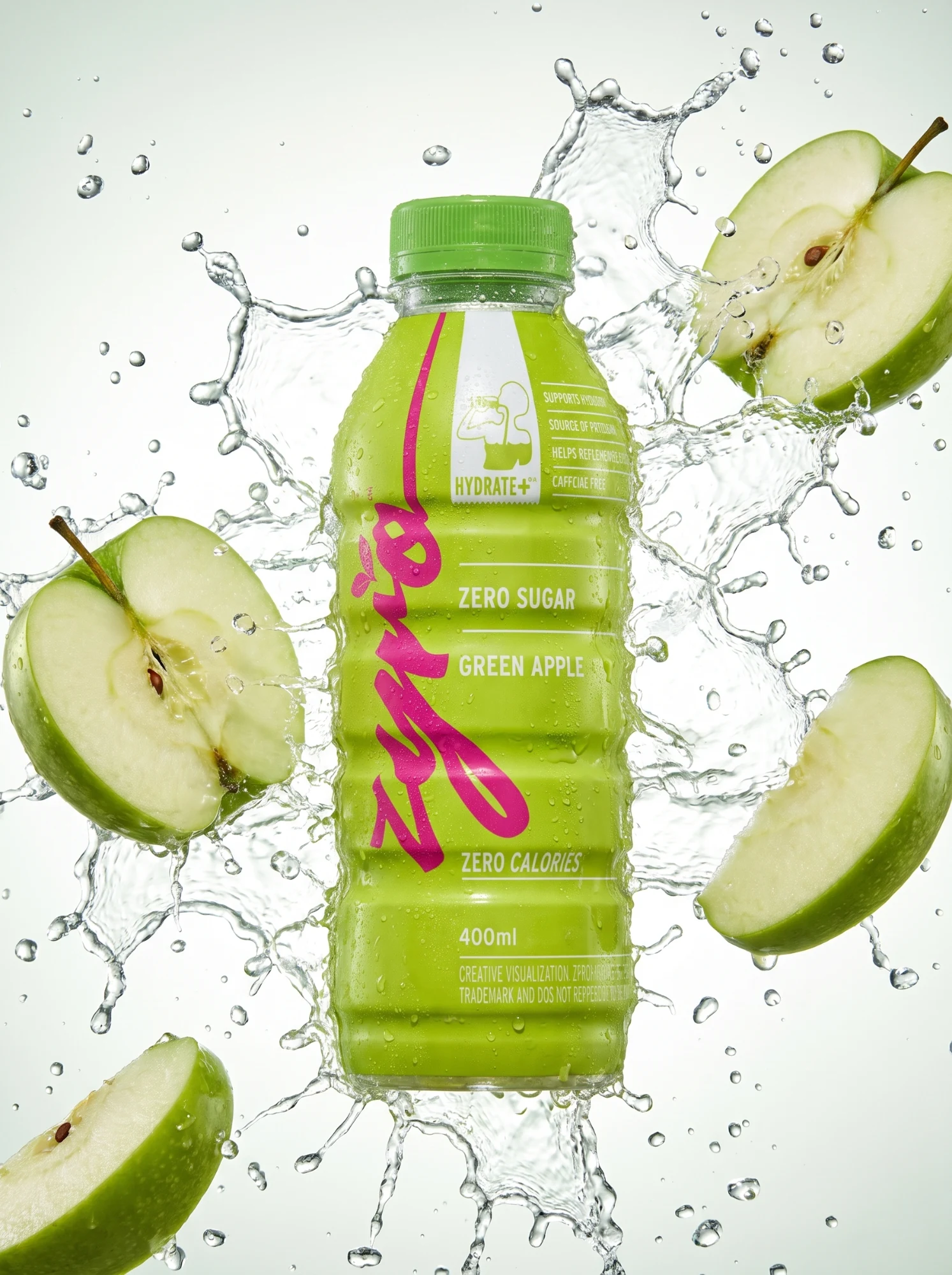 The green apple bottle is caught in a burst of water with apple halves flying round it.